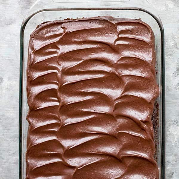 finished zucchini brownies frosted with chocolate frosting in swirl pattern
