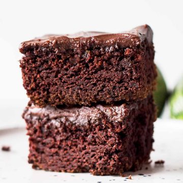 close up of two zucchini brownie slices stacked on top of each other