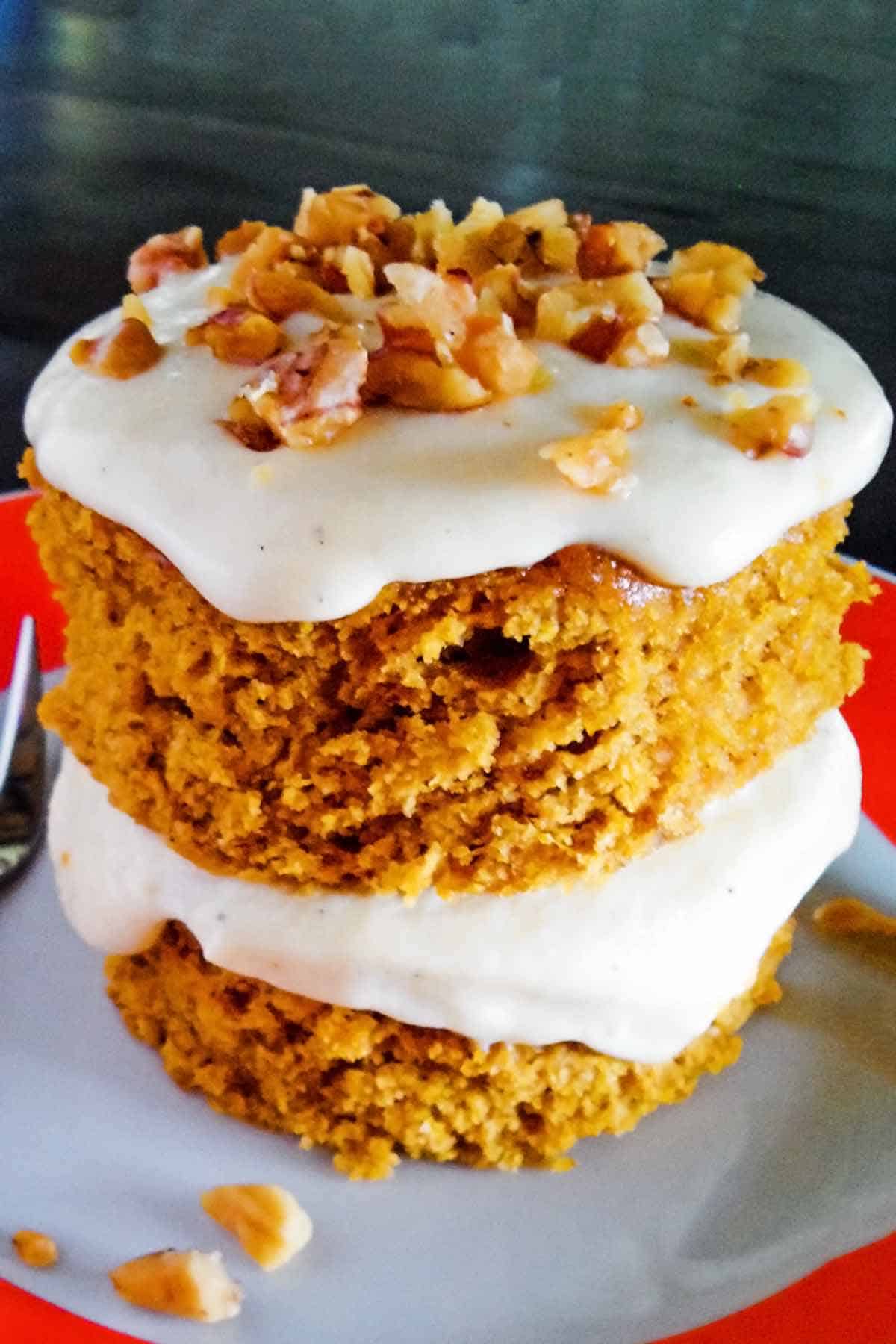 easy two layer pumpkin cake with cream cheese frosting and walnut topping