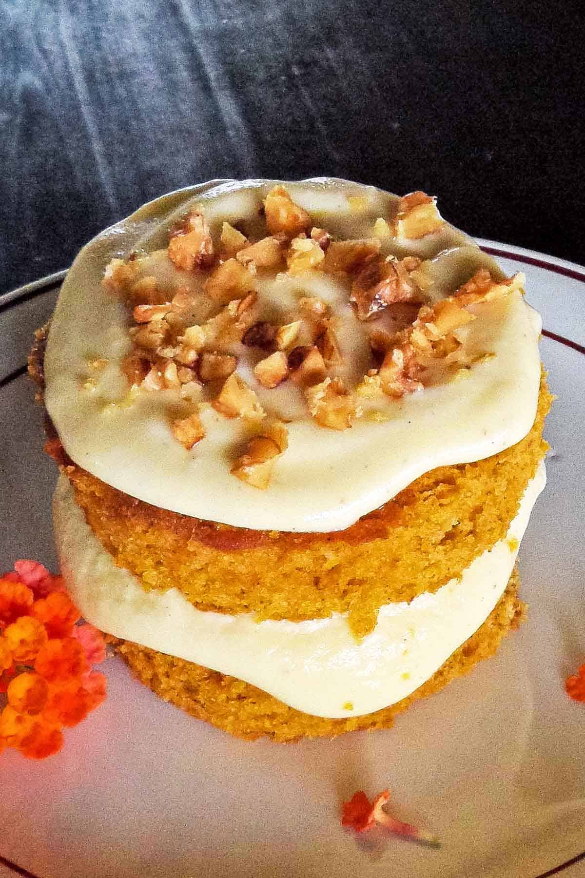 easy pumpkin cake on small white plate set on dark brown table