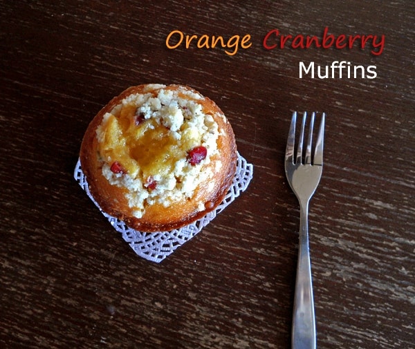 mandarin orange cranberry muffin on doily with fork on the side