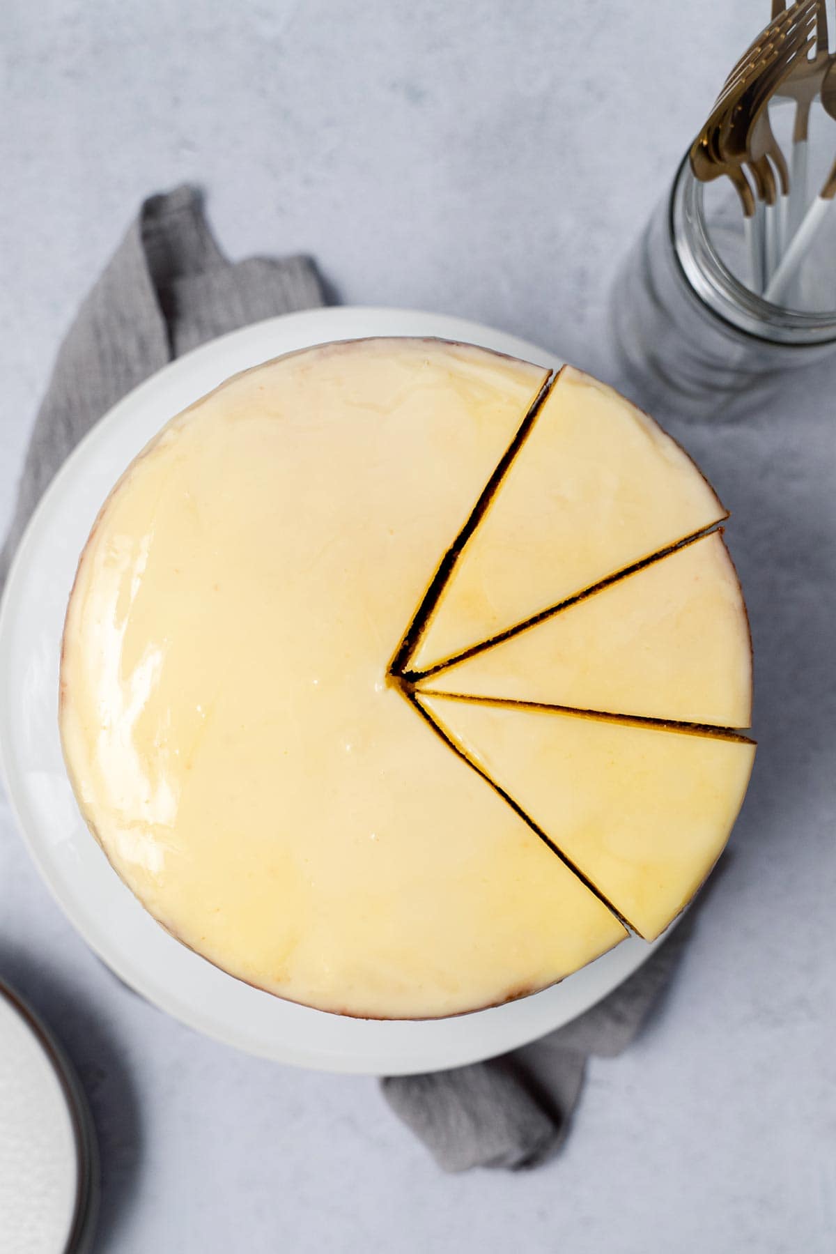 whole white chocolate cake with three cut slices