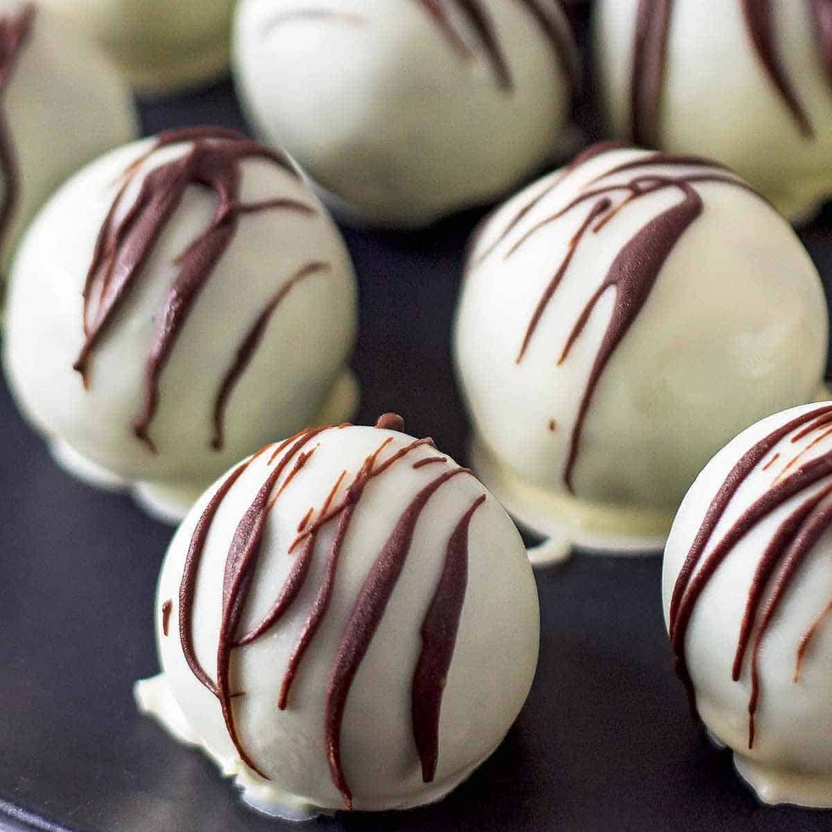 white chocolate oreo balls on black plate recipe