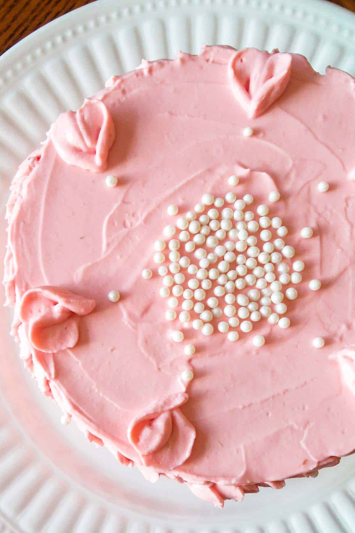 vanilla cake with strawberry filling from the top with sprinkle pearls