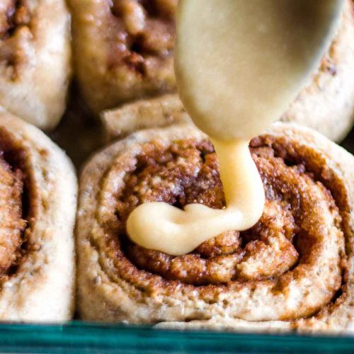 Healthy Cinnamon buns being glazed with icing