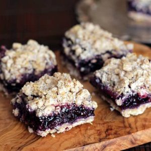 Blueberry apple crumble bar slices on wooden board