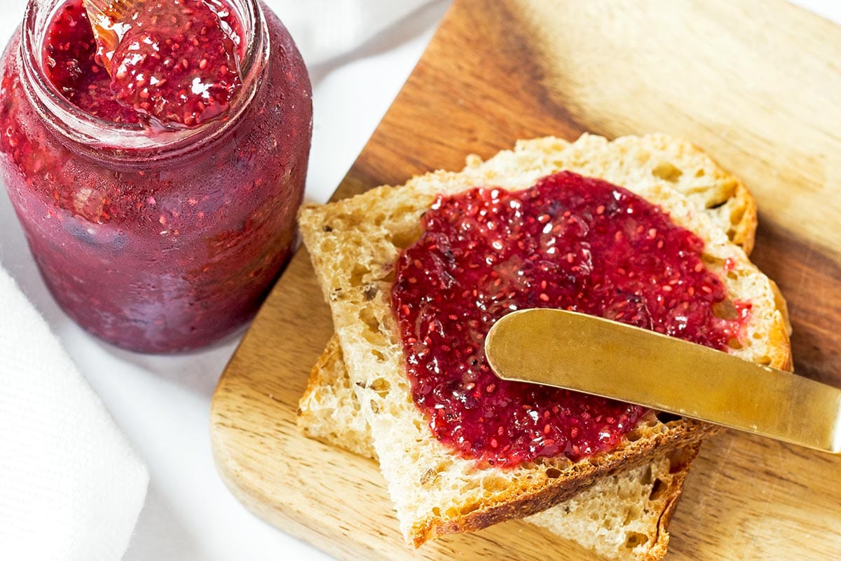 Spreading Strawberry jam on bread slice