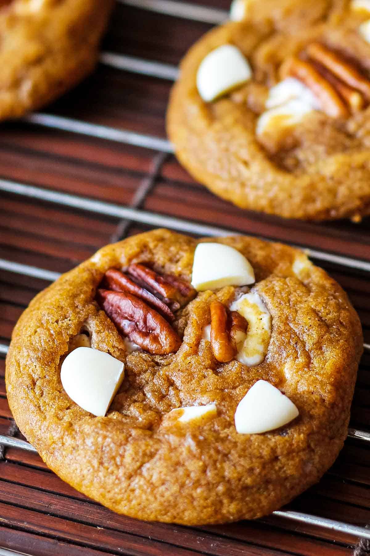 close up of pumpkin white chocolate chip cookies with pecans