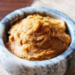 almond pumpkin butter spread in small gray and white marble bowl