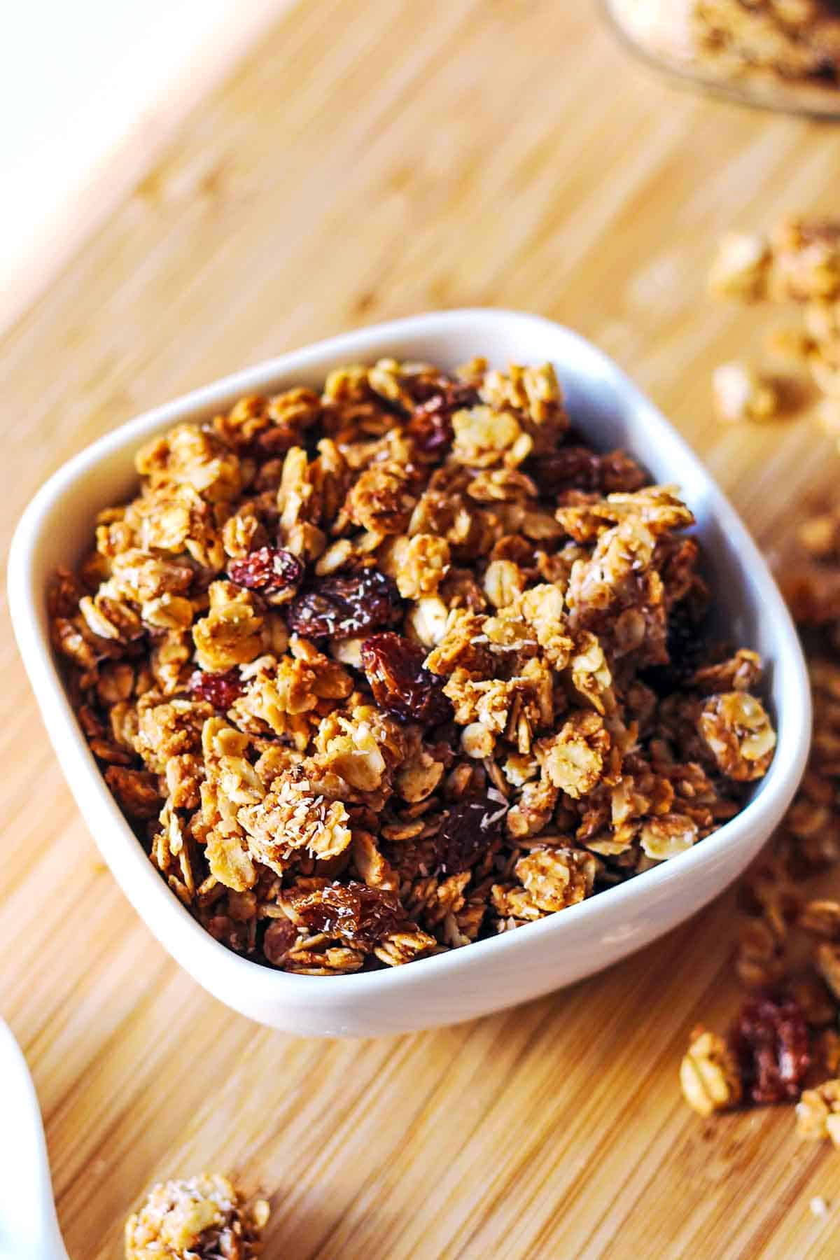 small white bowl of granola made with almond butter