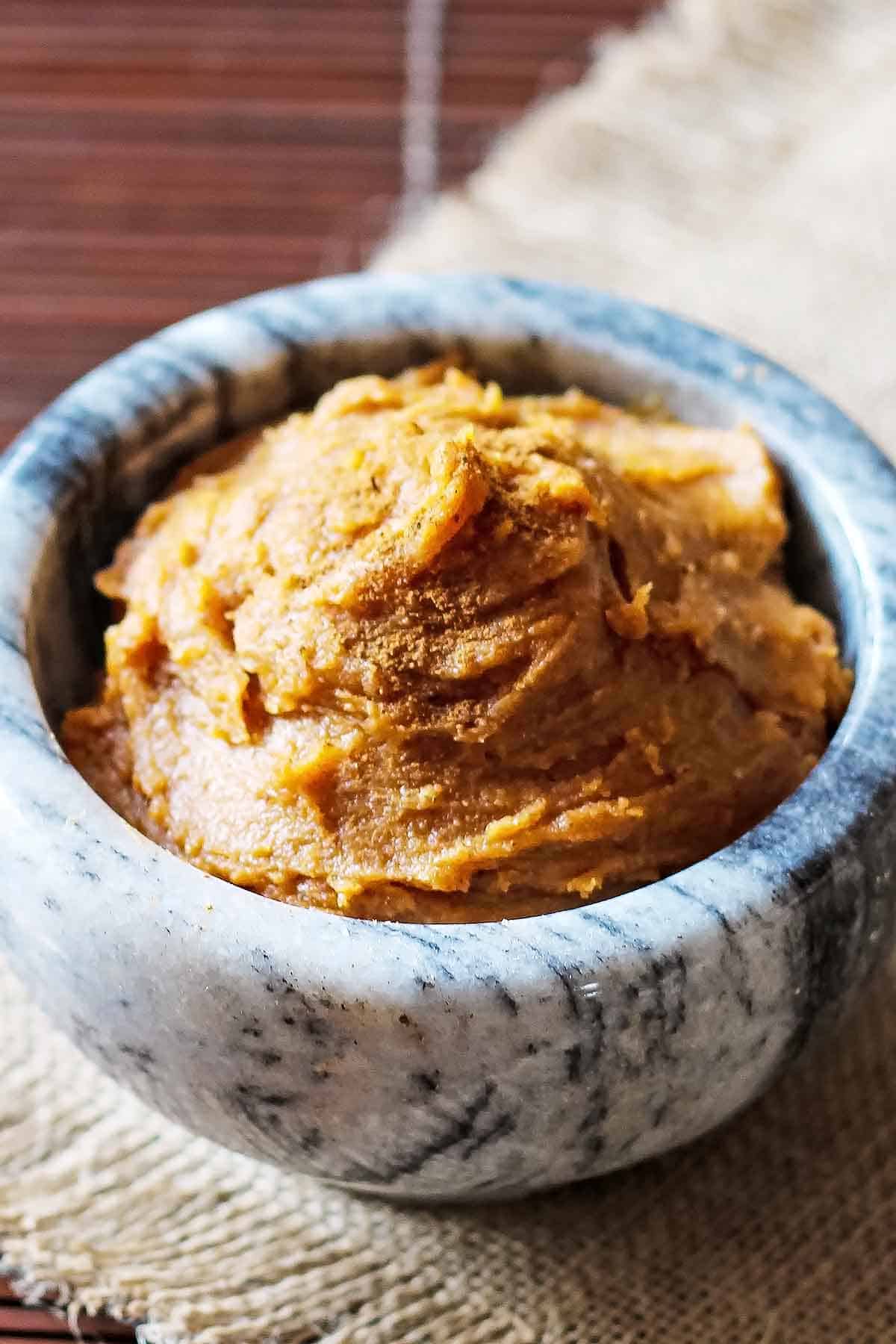 close up of pumpkin almond butter in marble bowl