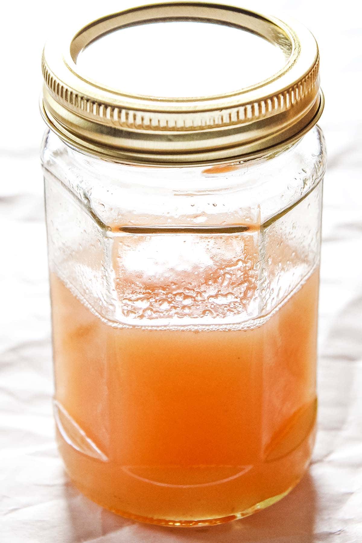 finished rhubarb cocktail syrup in glass jar