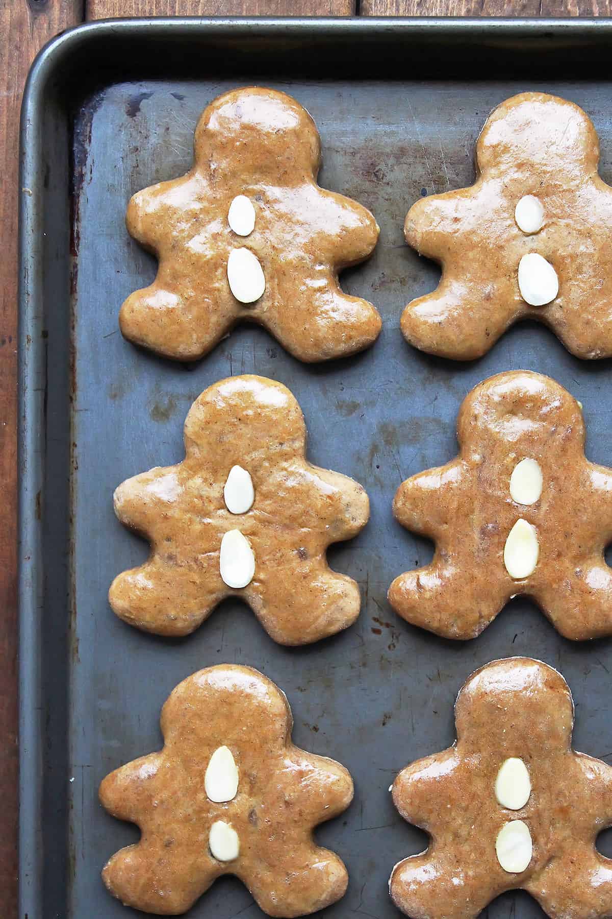 Lebkuchen Gingerbread Men with almond buttons on baking sheet