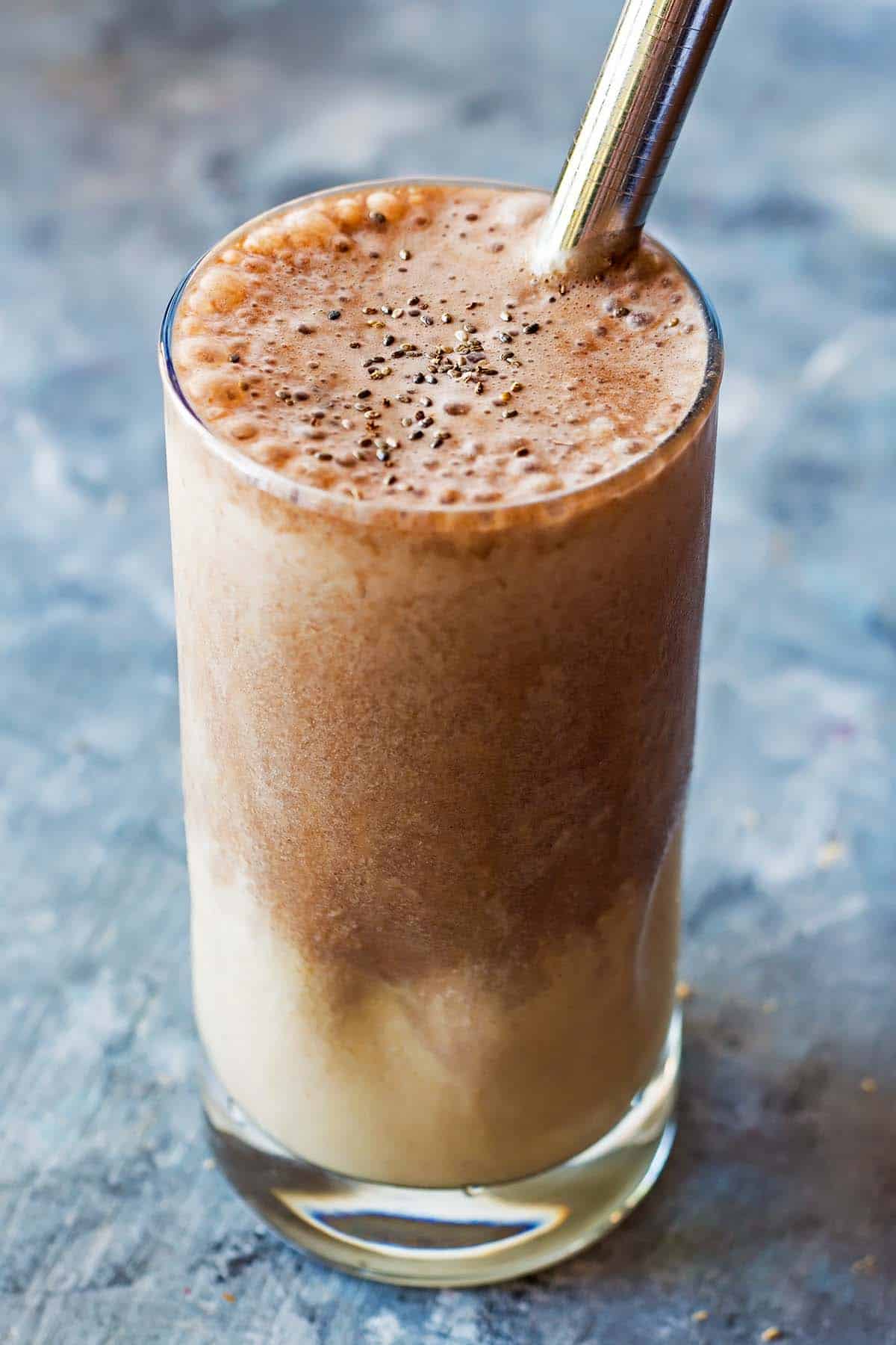 two layers smoothie in a glass, peanut butter smoothie on the bottom and chocolate on top