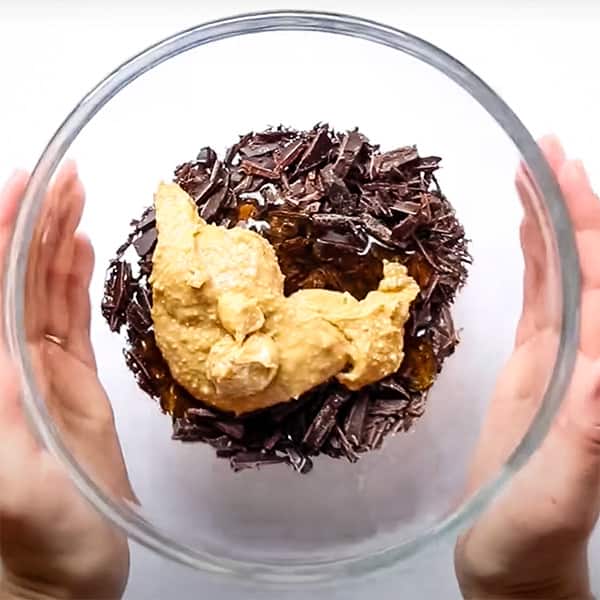 chopped chocolate, honey, and peanut butter in glass bowl