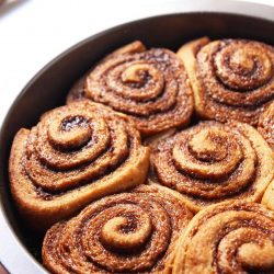 Whole Wheat Gingerbread Cinnamon Rolls make for a cozy Christmas breakfast treat. Molasses and an aromatic spice mix give these sweet rolls their unmistakable gingerbread flavor. This recipe is made with whole wheat flour and refined sugar free.