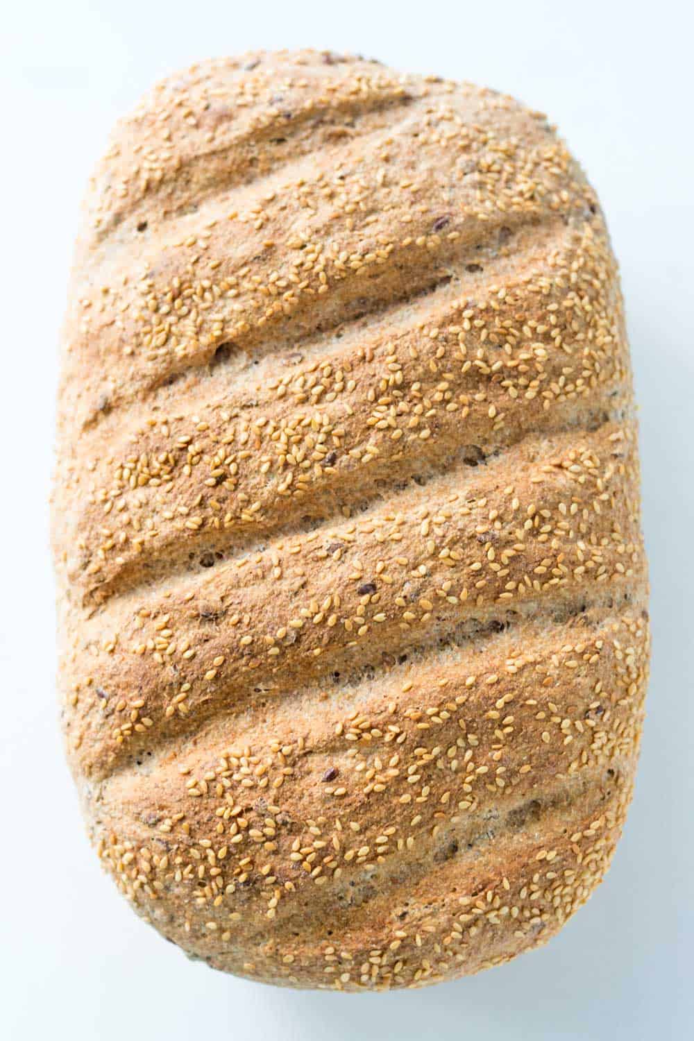This nutritious Whole Grain Spelt Bread Recipe with flax and sesame seeds is super easy to make. You ca bake the dough in a loaf pan or Dutch oven.