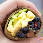 This Healthy Black Bean Breakfast Burrito Recipe features a hearty bean & hash brown filling with scrambled eggs, cheese, avocado and salsa rolled into whole wheat tortillas. This is a great healthy breakfast idea that can also be made ahead.