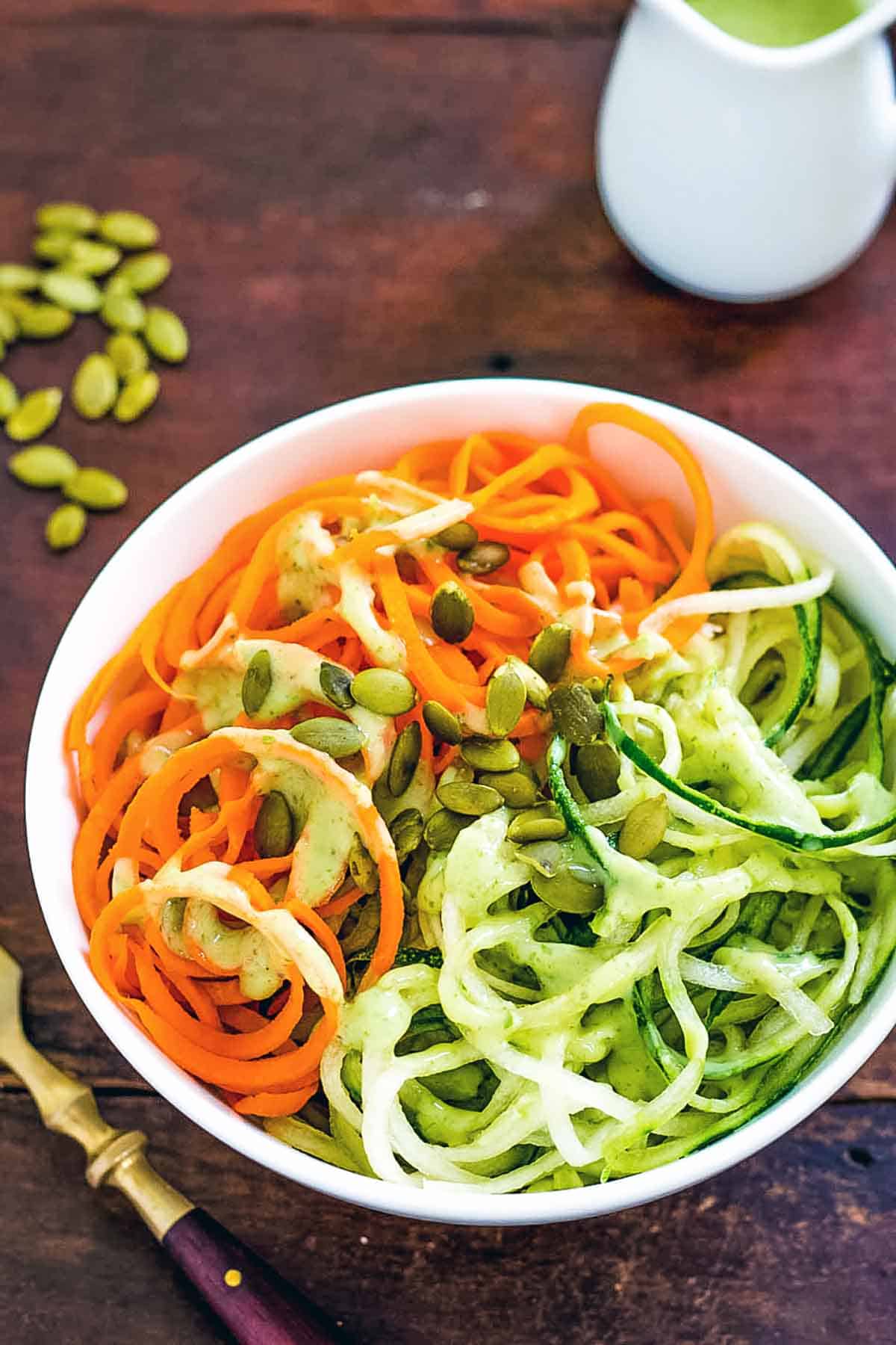 Spiralized Cucumber Carrot Salad with avocado dressing on the side