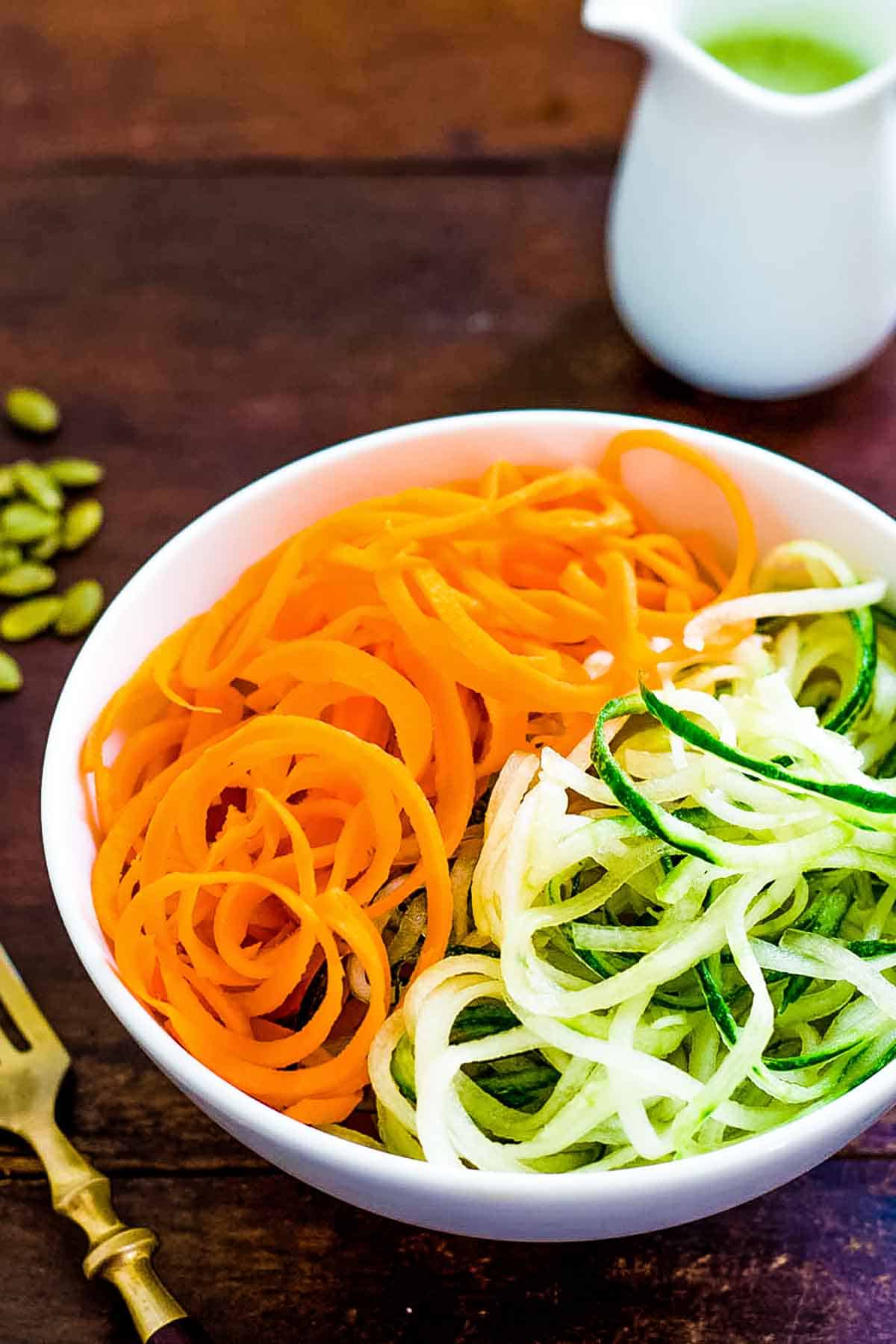 Carrot and cucumber strands in salad bowl