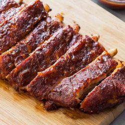 Rack of cut Instant Pot Ribs on a cutting board