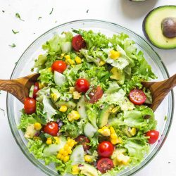 Overhead view of Avocado Corn Salad in a glass bowl