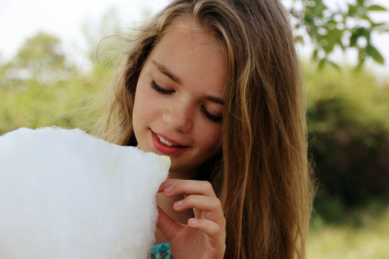 girl eating cotton candy