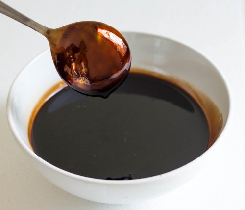 Balsamic reduction coating back of a spoon