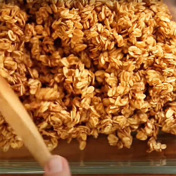 spreading granola in baking dish