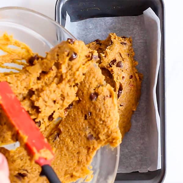 pouring pumpkin bread batter