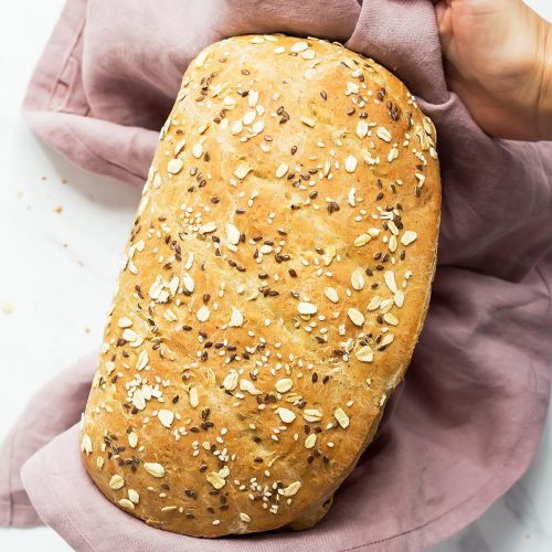 Hands holding sourdough bread