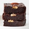 Stack of 3 fudgy coconut flour brownies with pecans
