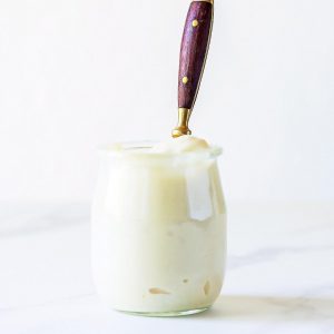 Little jar of mayonnaise with spoon