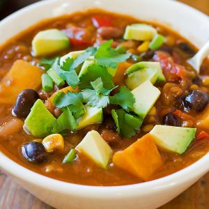 Bowl of Vegan Lentil Chili topped with avocado and cilantro