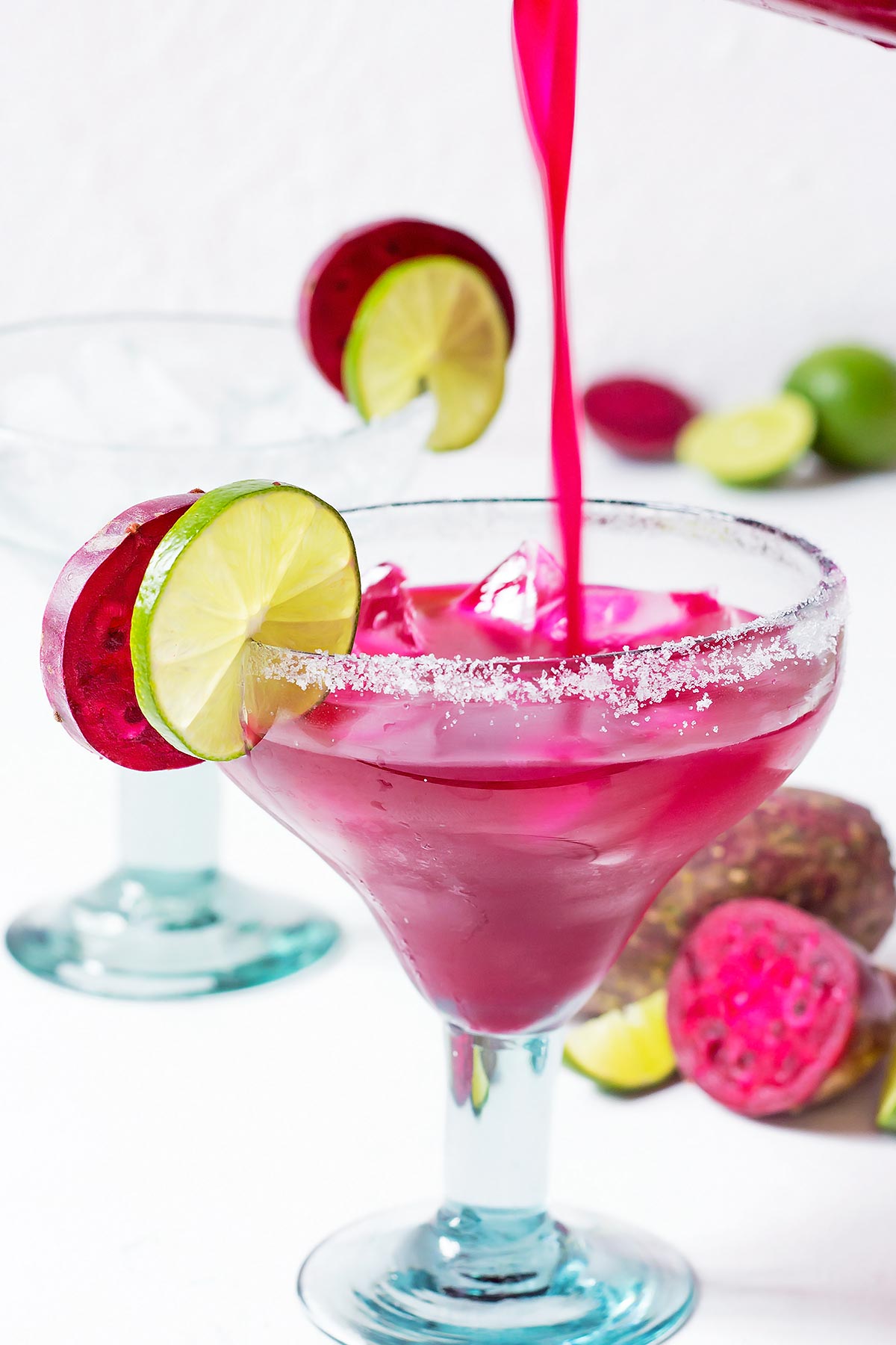 Pouring Prickly Pear Margarita into glass