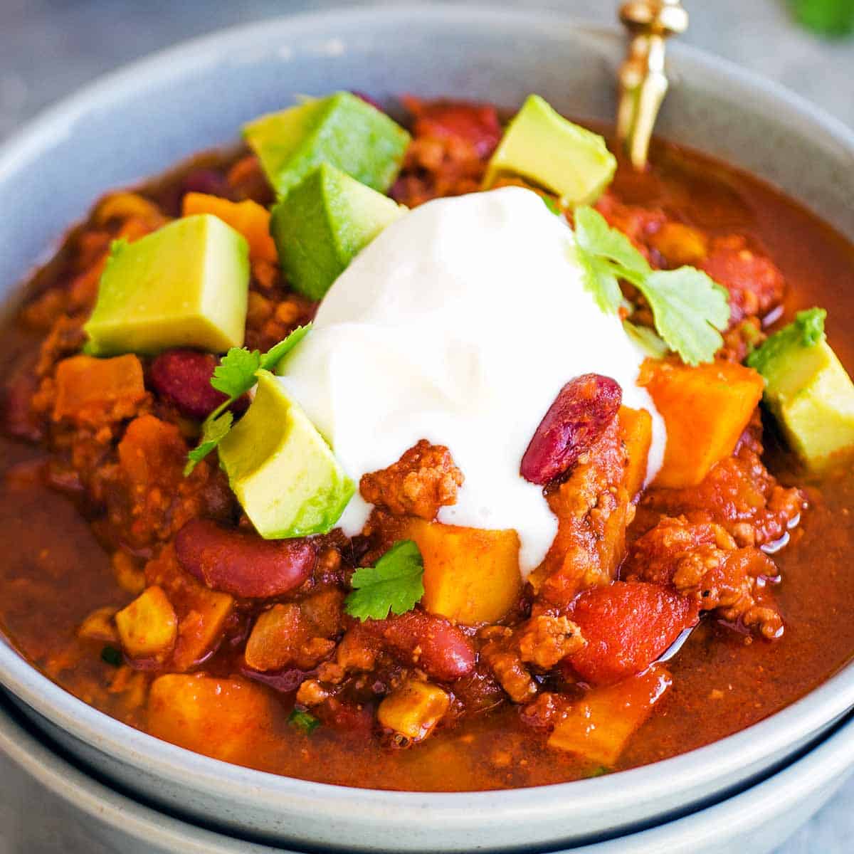 Slow Cooked Sweet Potato Chili with golden spoon