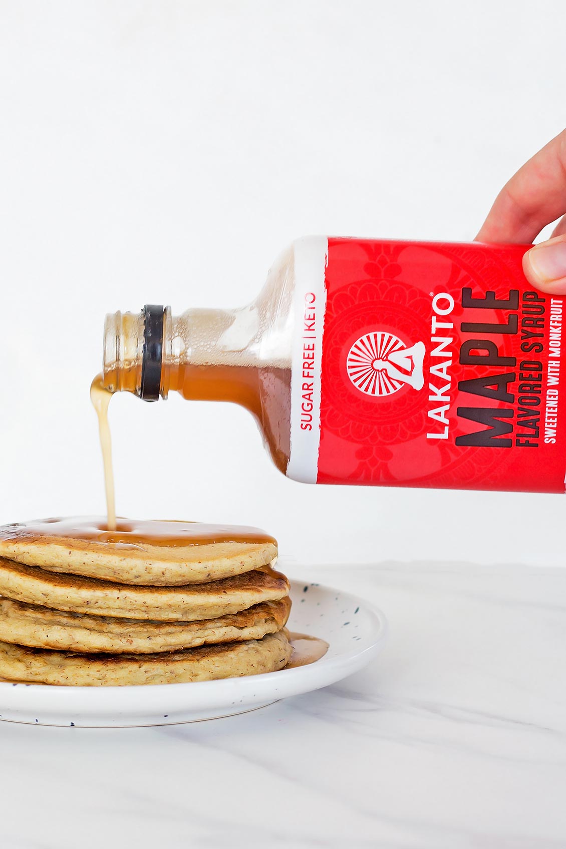Lakanto Maple Syrup Substitute pouring over pancakes