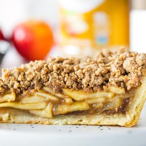 Closeup of slice of apple pie with crumb topping