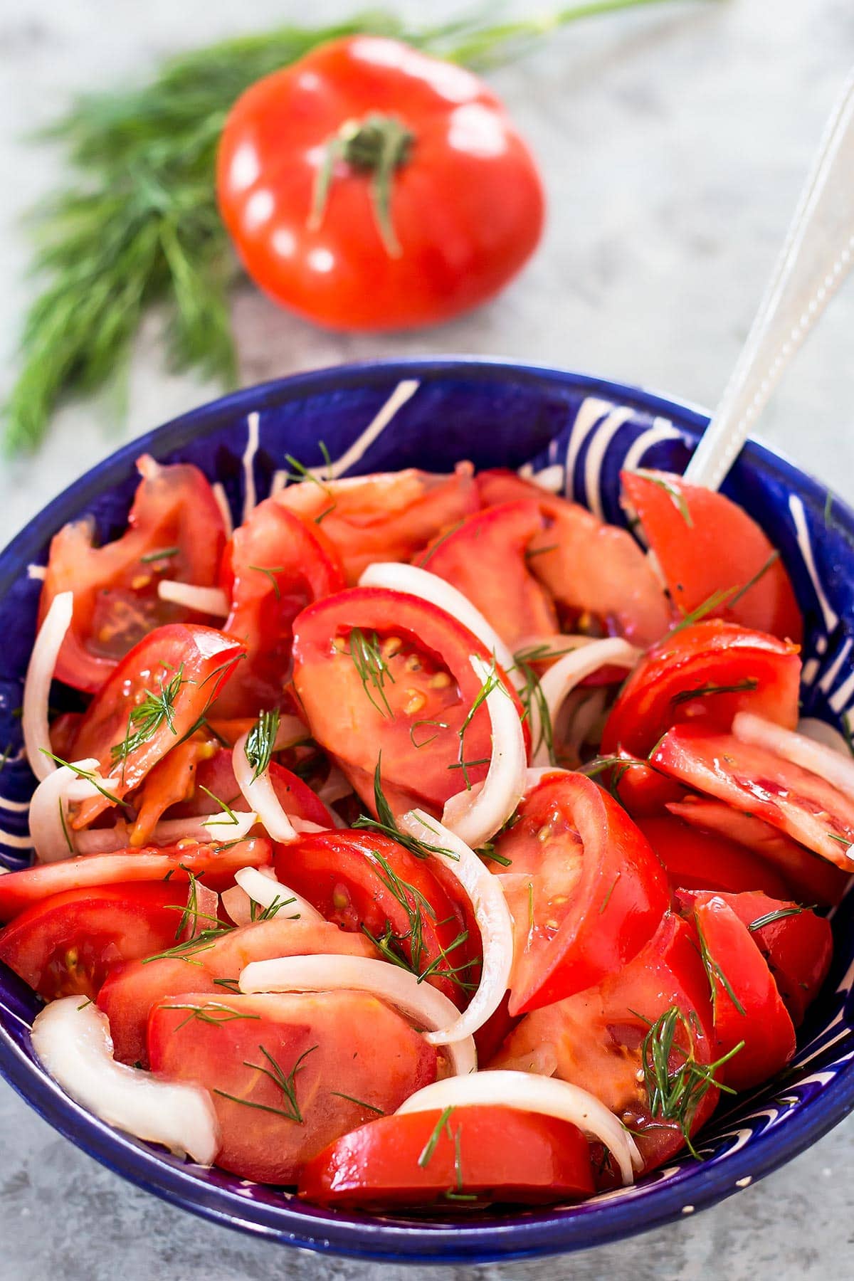 Tomato Onion Salad in blue serving bowl