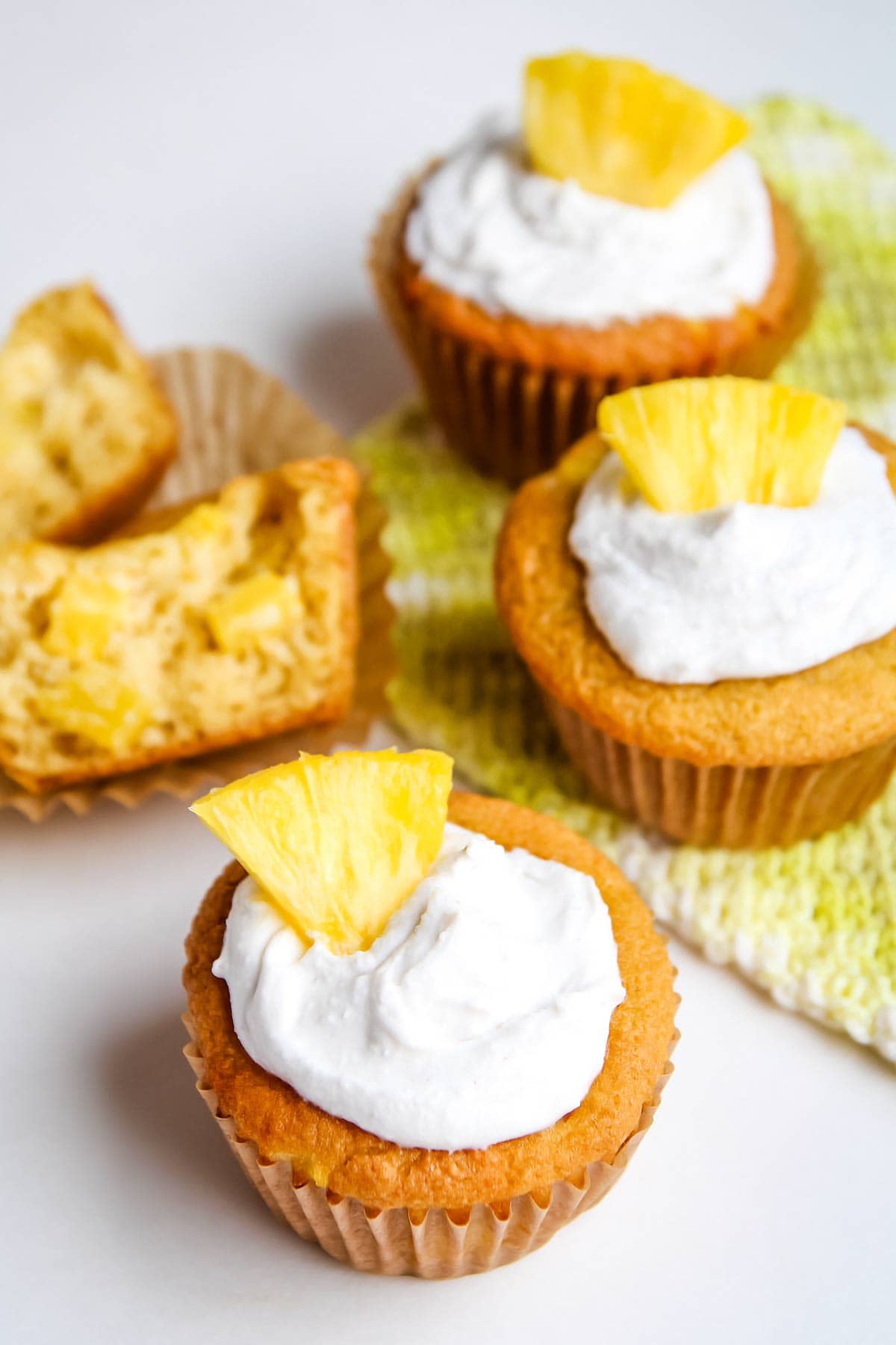 Gluten free pineapple muffins with cross-cut section in background