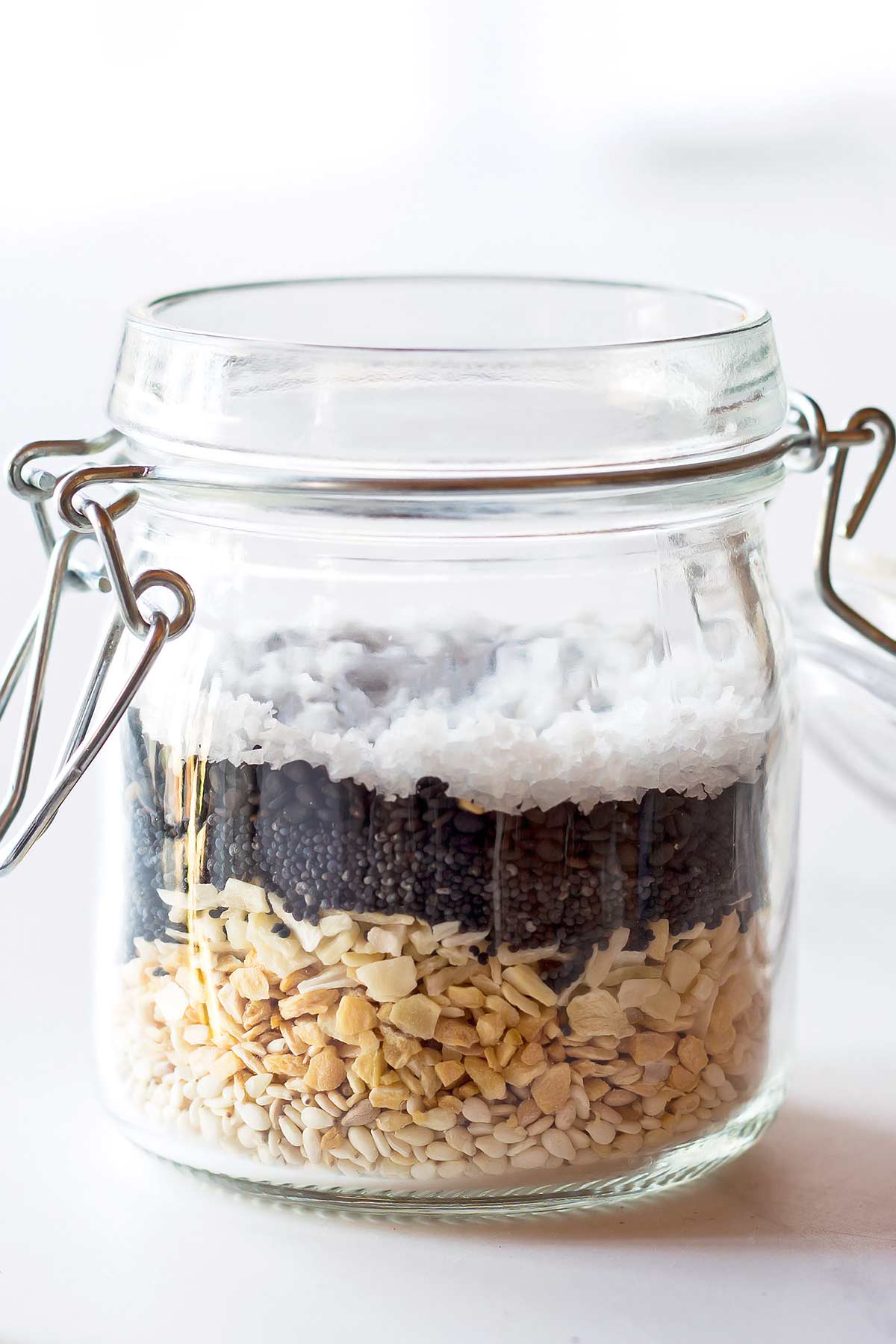 Everything but the Bagel Seasoning ingredients layered in small glass jar
