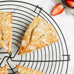 Coconut flour scones on circular wire rack, strawberries on the side