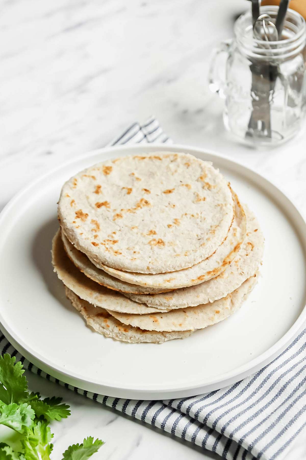 Coconut Flour Tortillas stacked on a white plate