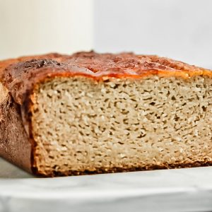 Cut open loaf of paleo banana bread with coconut flour