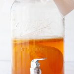 Homemade Kombucha brewing in large glass dispenser
