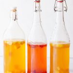 three glass bottles with flavored kombucha