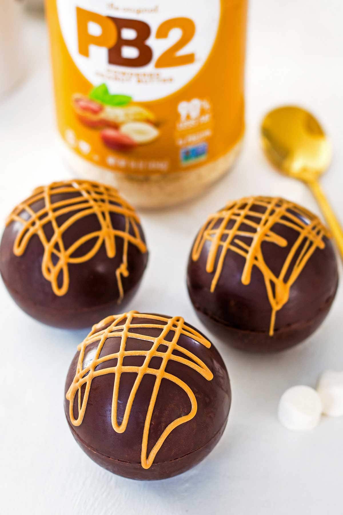 peanut hot chocolate bombs with pb2 powdered peanut butter in jar