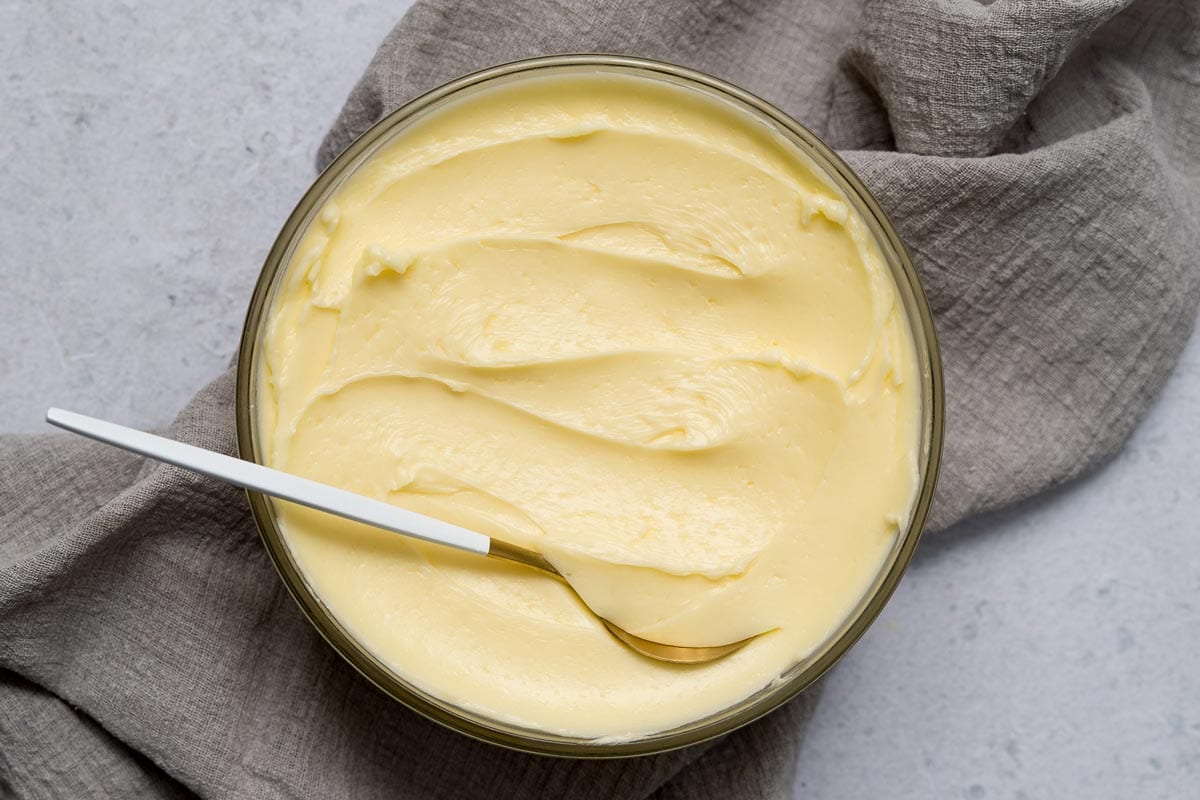 Easiest Swiss meringue buttercream in bowl with golden spoon