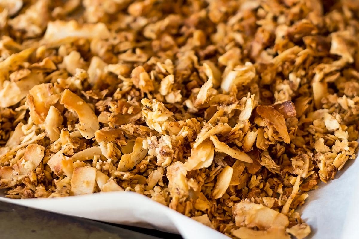 Paleo Granola with sliced tigernut on parchment lined baking sheet
