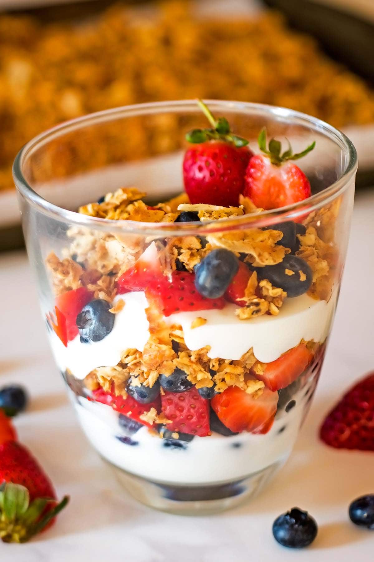 Tigernut granola parfait with layers of yogurt, berries, and granola